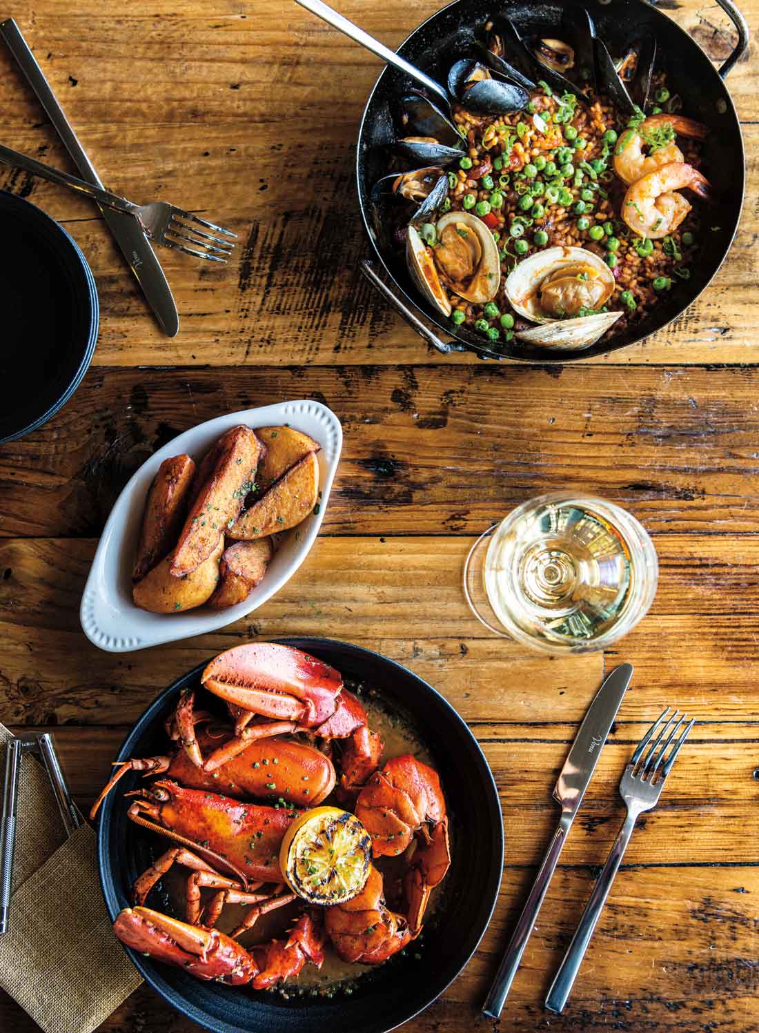 From Wiscasset's Water Street Kitchen & Bar: paella with Maine mussels and littlenecks; roasted lobster with whiskey- tarragon butter; truffle fries