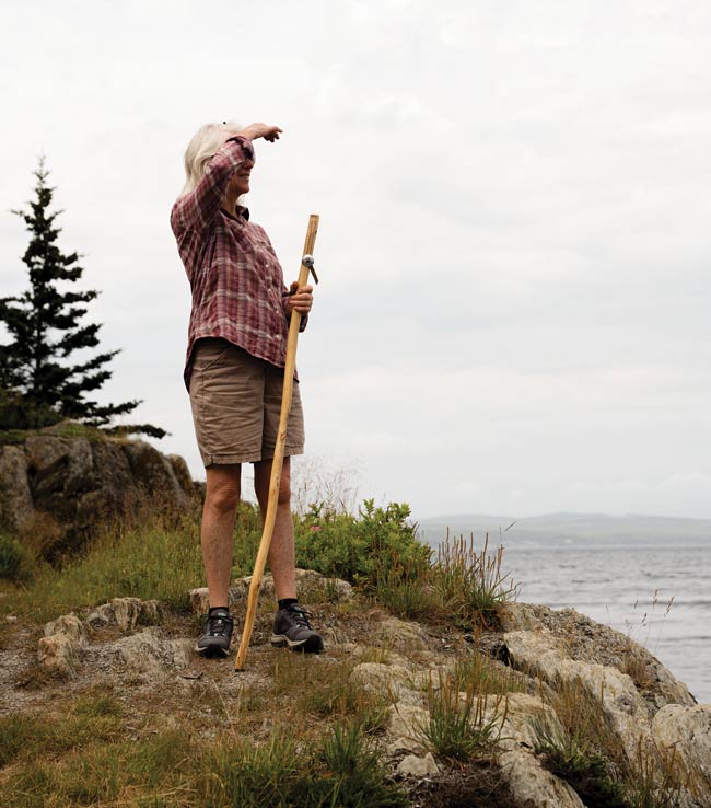 woman hiking with a Greyfeather Woodcraft walking stick