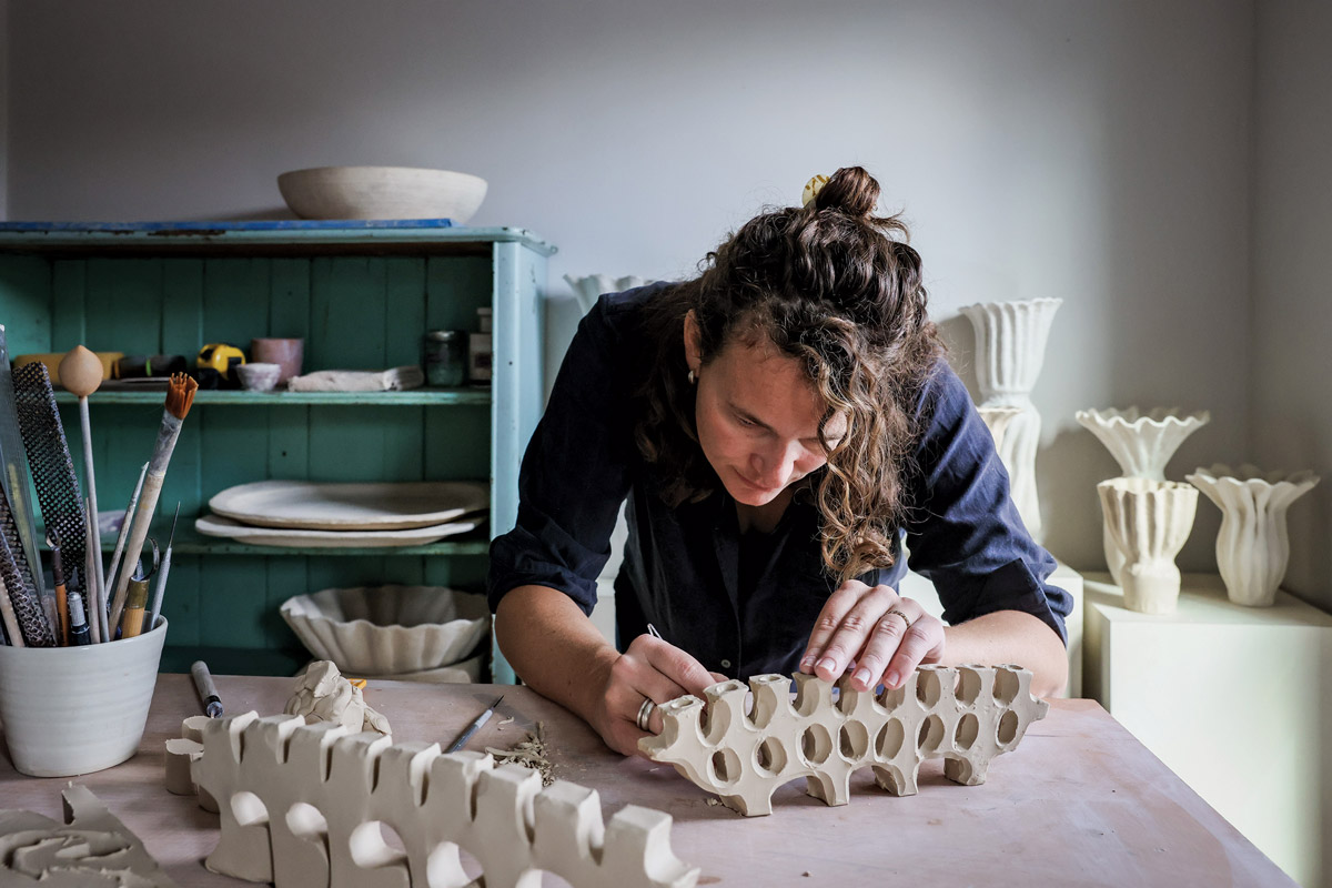 Ariela Nomi Kuh of ANK Ceramics sculpting one of her menorahs