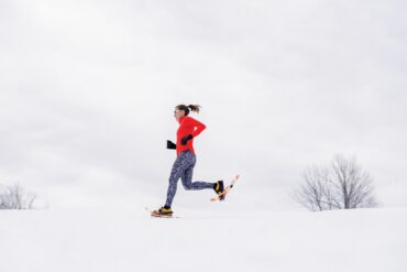 Woman running on snowshoes
