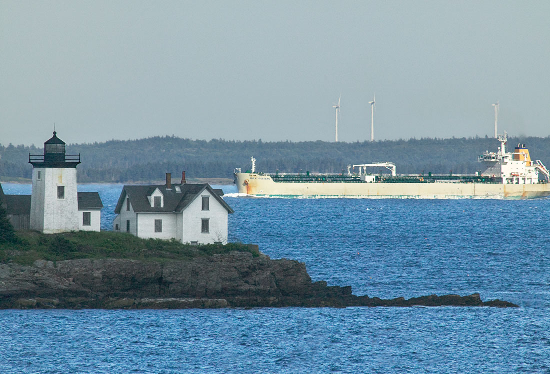 Rockport’s Indian Island Light in the foreground with a oil/chemical tanker ship and wind mills in the background