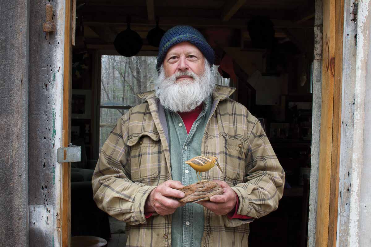 Jeff Yorks with a bird carving by F.M. Kilburn
