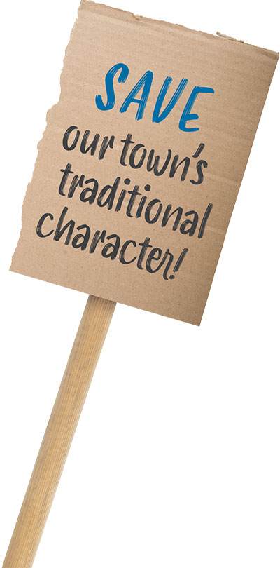 cardboard sign that reads "SAVE our town's traditional character!"