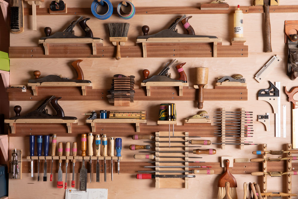 wall of furniture-making tools in Aspen Golann's Berwick workshop