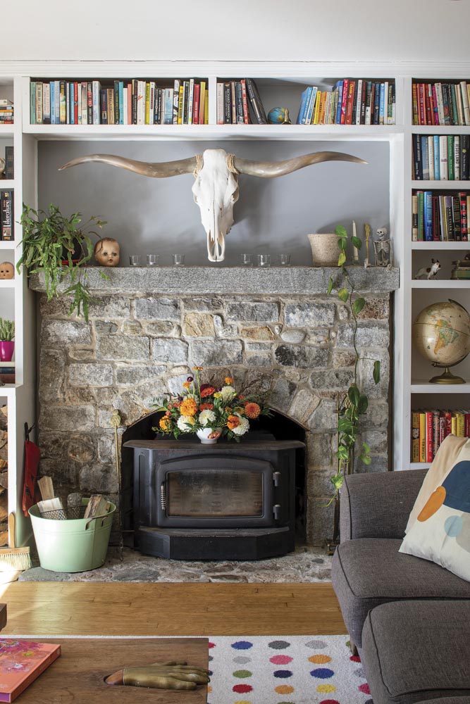 In Anika Wilson and Giles Healey’s living room, a bouquet by Wilson, who owns Bad Rabbit Flowers, and a bull skull set off the granite fireplace